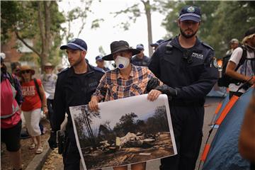 Protesters denounce prime minister's holiday leave amid Australia fire crisis