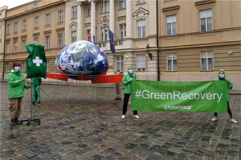 Greenpeace activists project visuals with Green Recovery messages 