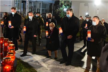 Molitva i paljenje svijeća ispred Nacionalne memorijalne bolnice Vukovar