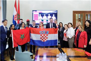 Croatian MPs and Moroccan ambassador together watching Group's opener