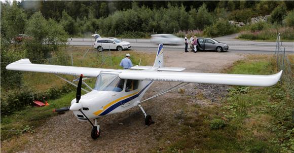 SWEDEN LIGHT PLANE LANDS ON HIGHWAY