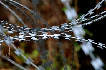 Croatian-Slovenian protest volleyball match across razor wire fence Saturday