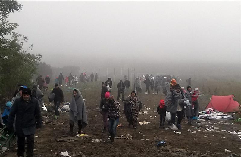 Migrants try to break through police barricade and cross into Croatia