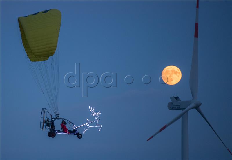 Santa Claus flies on a motor glider in Germany