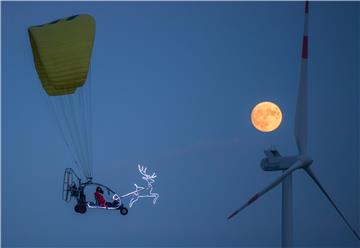 Santa Claus flies on a motor glider in Germany