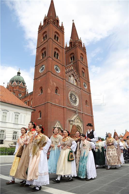 Folklore groups walk in procession at Djakovo festival