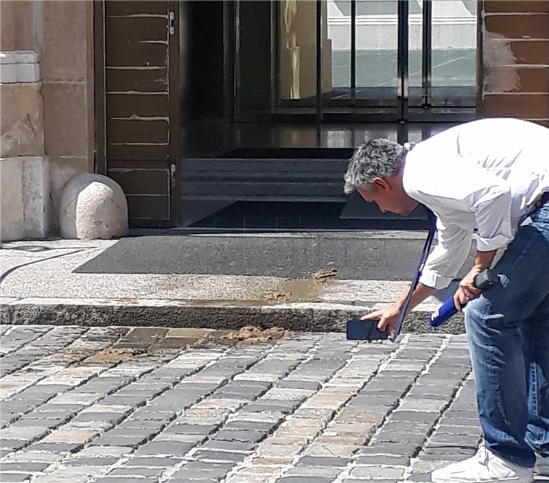 Journalist throws bucket full of feces at government entrance